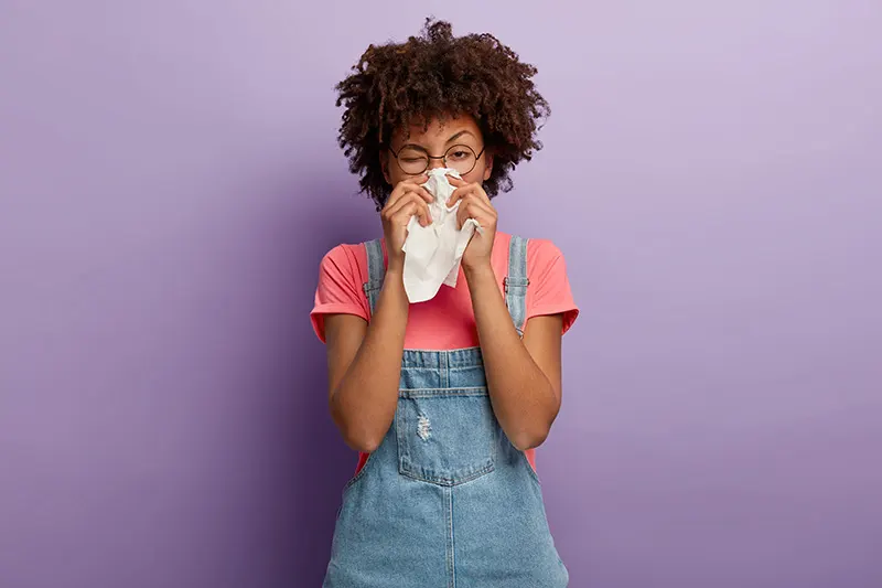 a woman blowing her nose